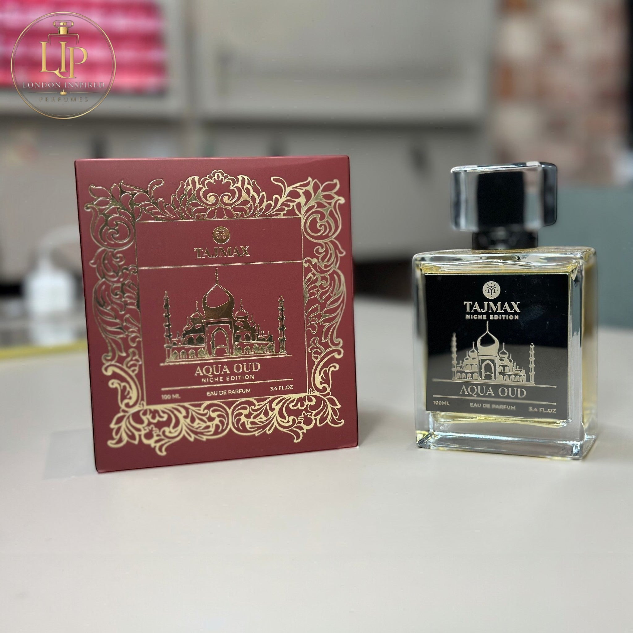 Taj Max Aqua Oud perfume bottle and packaging on a white background