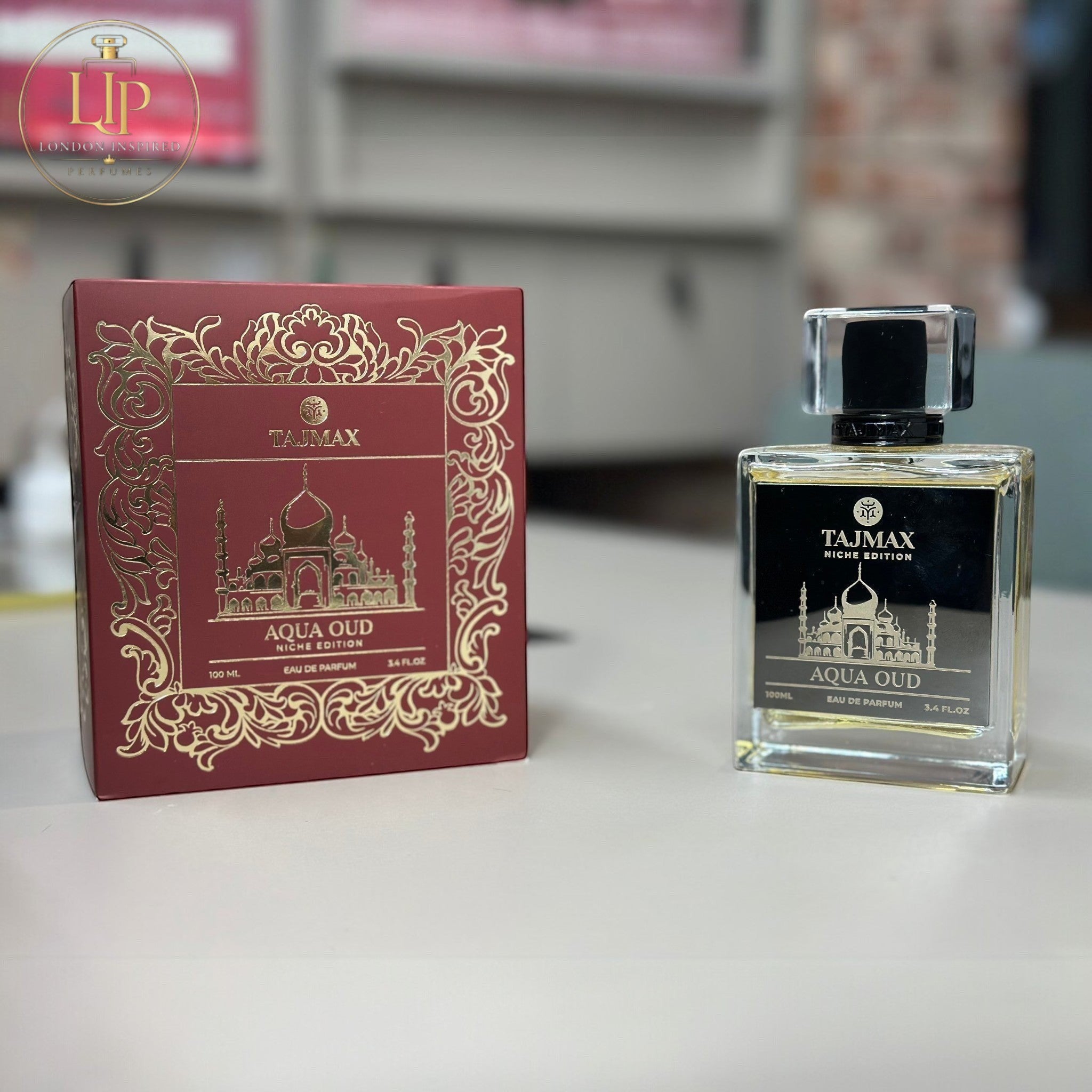 Taj Max Aqua Oud perfume bottle and packaging on a white background