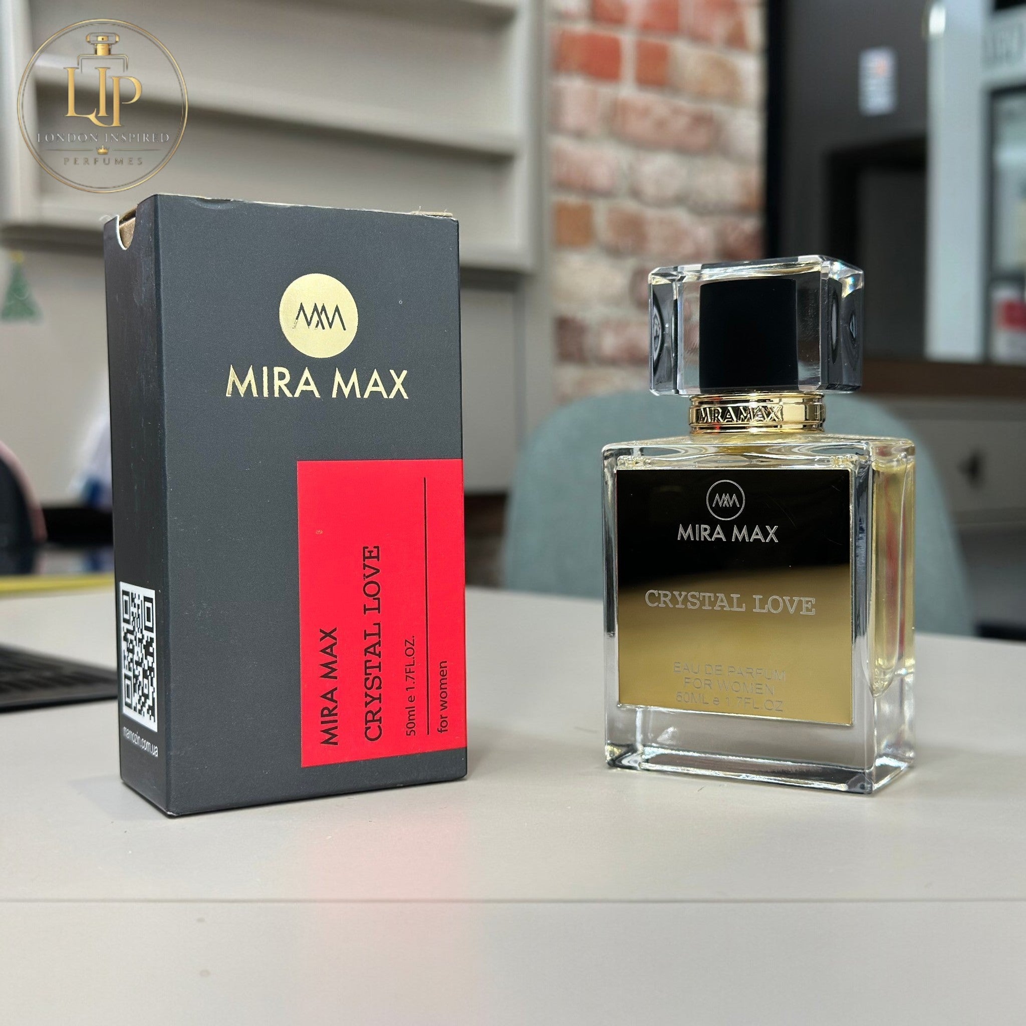 Mira Max Crystal Love perfume bottle and packaging on a table.
