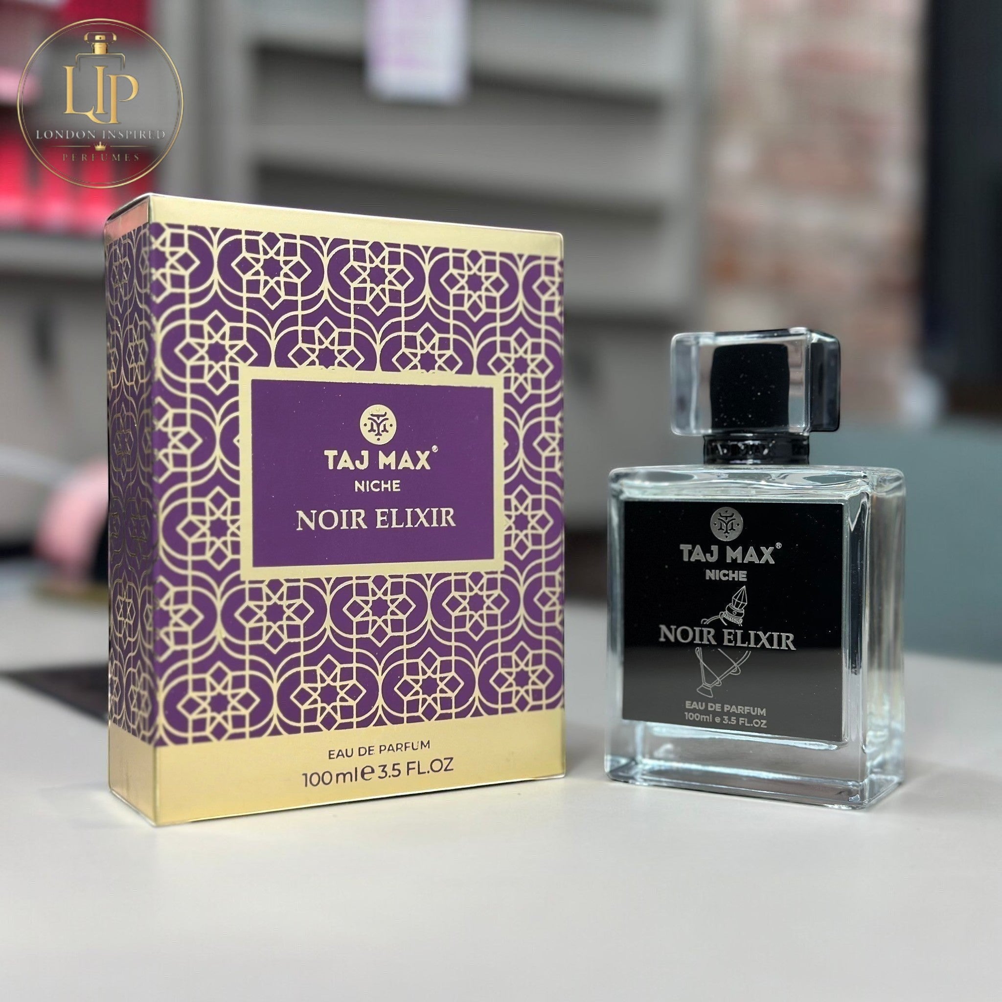 Taj Max Noir Elixir perfume bottle and packaging on a table.