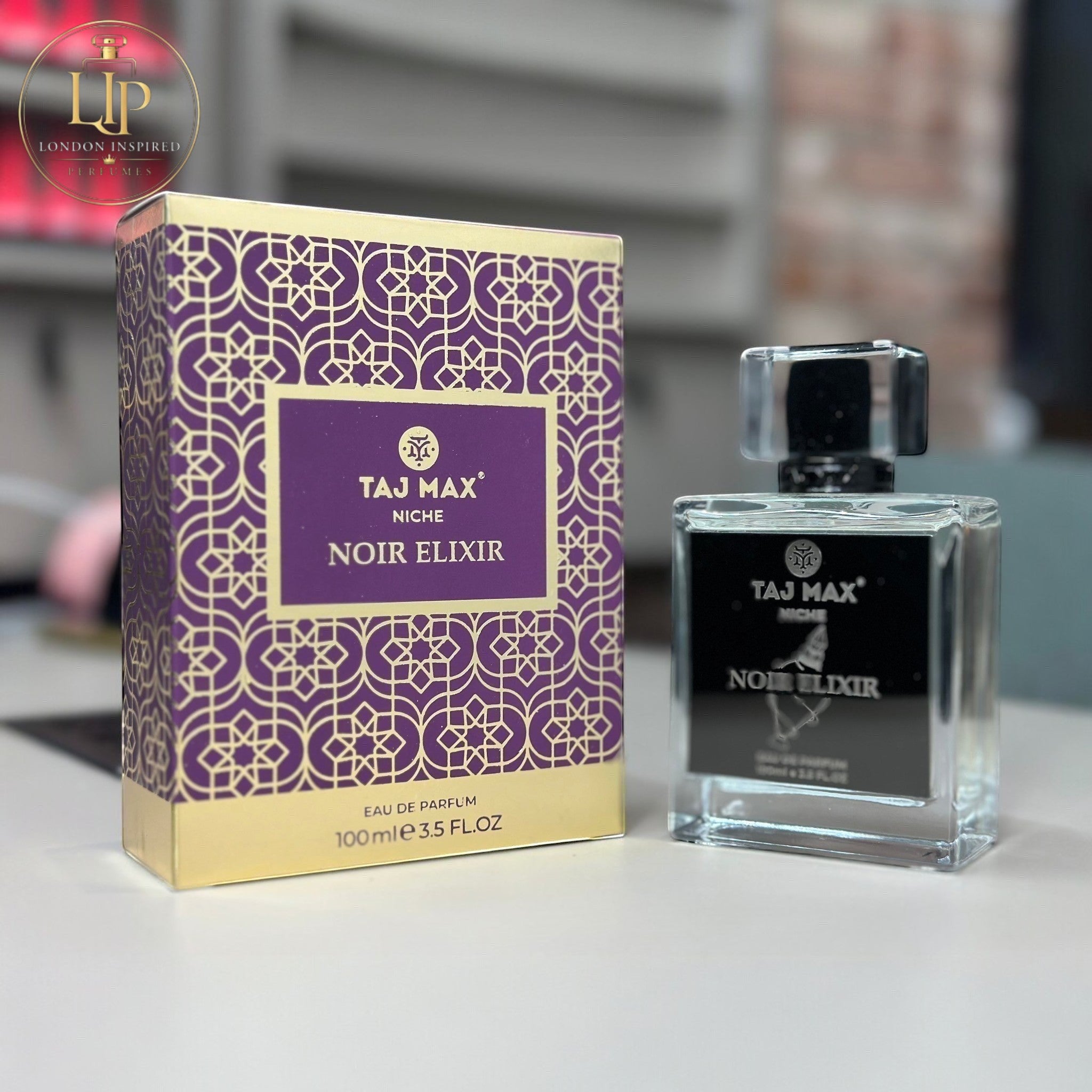 Taj Max Noir Elixir perfume bottle and packaging on a table