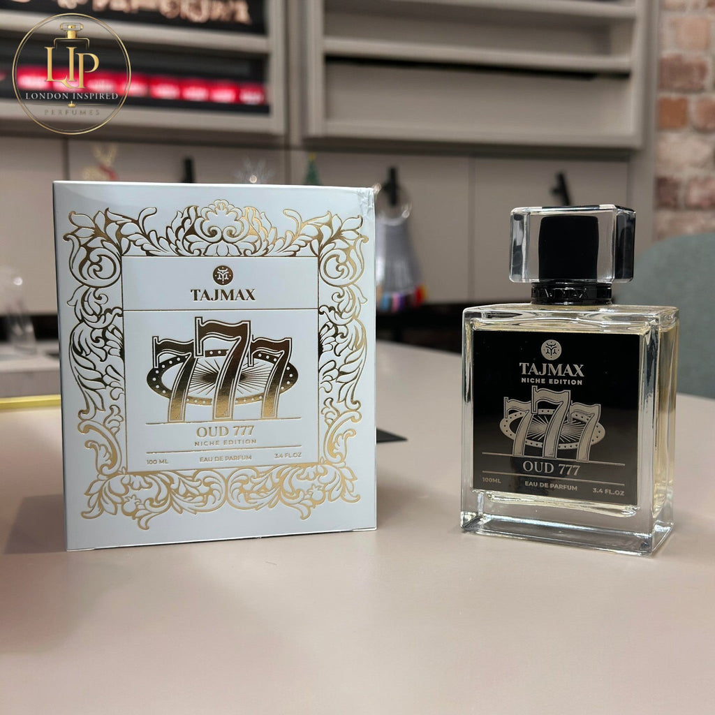 Tajmax Oud 777 perfume bottle and packaging on a kitchen counter.