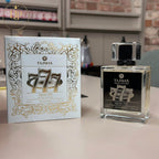 Tajmax Oud 777 perfume bottle and packaging on a table