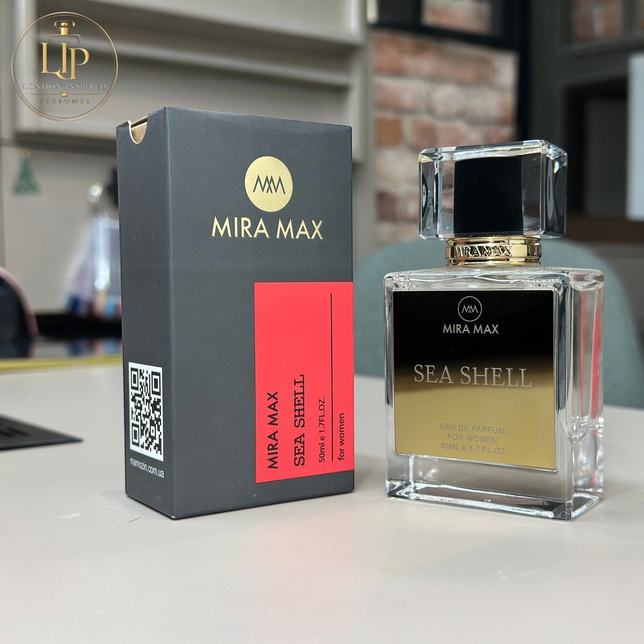MIRA MAX Sea Shell perfume bottle and packaging on a surface with a blurred background