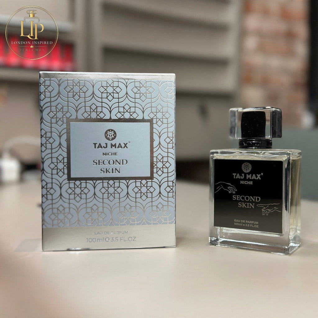 Perfume bottle and packaging of TAJ MAX Niche Second Skin on a blurred background