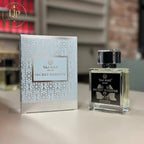 Perfume bottle and packaging of Taj Max Secret Whisper on a table.