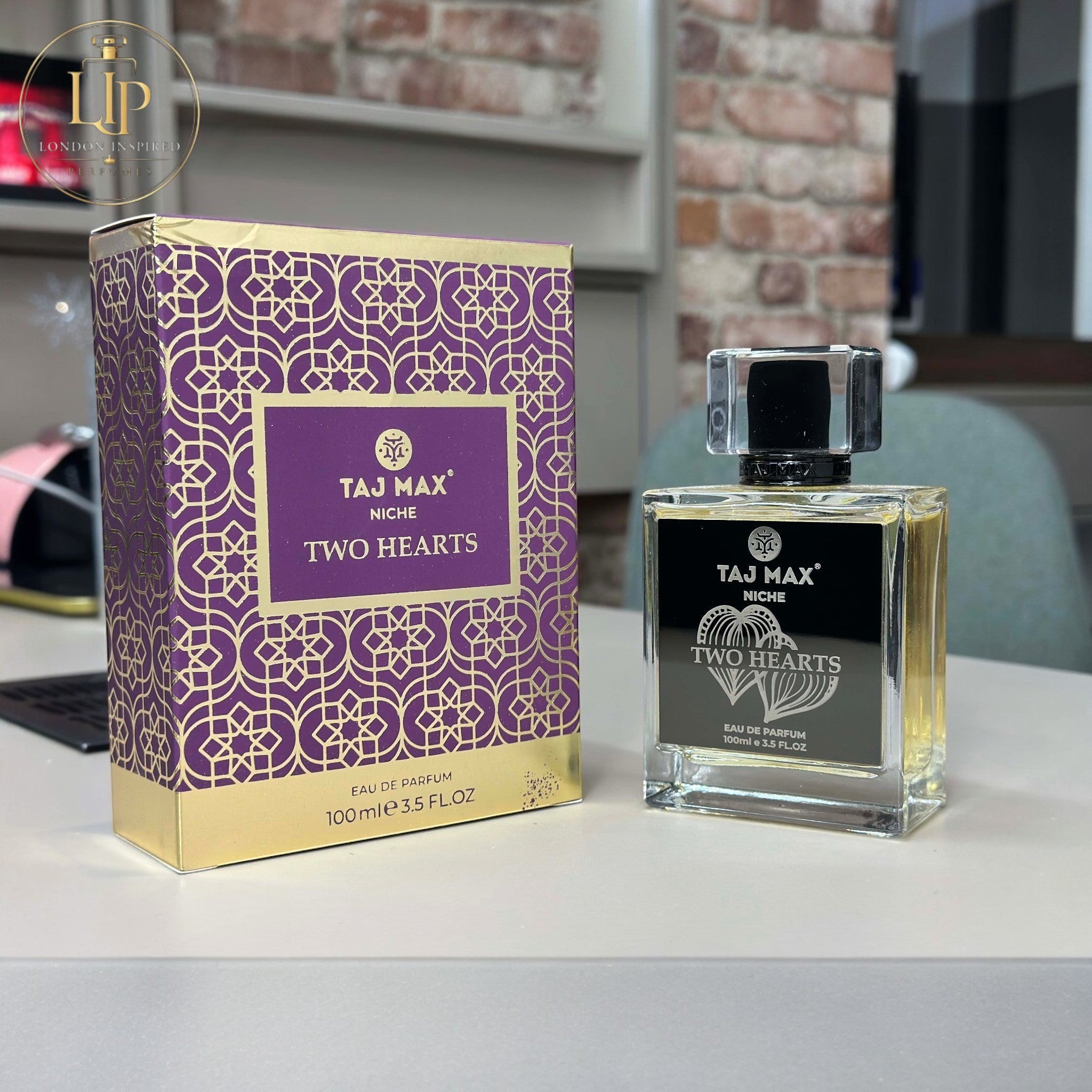 Taj Max Niche Two Hearts perfume bottle and packaging on a table.