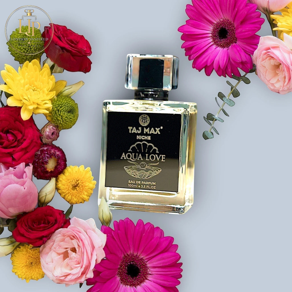 London Inspired Perfumes TAJ Max AQUA LOVE Eau de Parfum 100ml bottle surrounded by colorful fresh flowers.